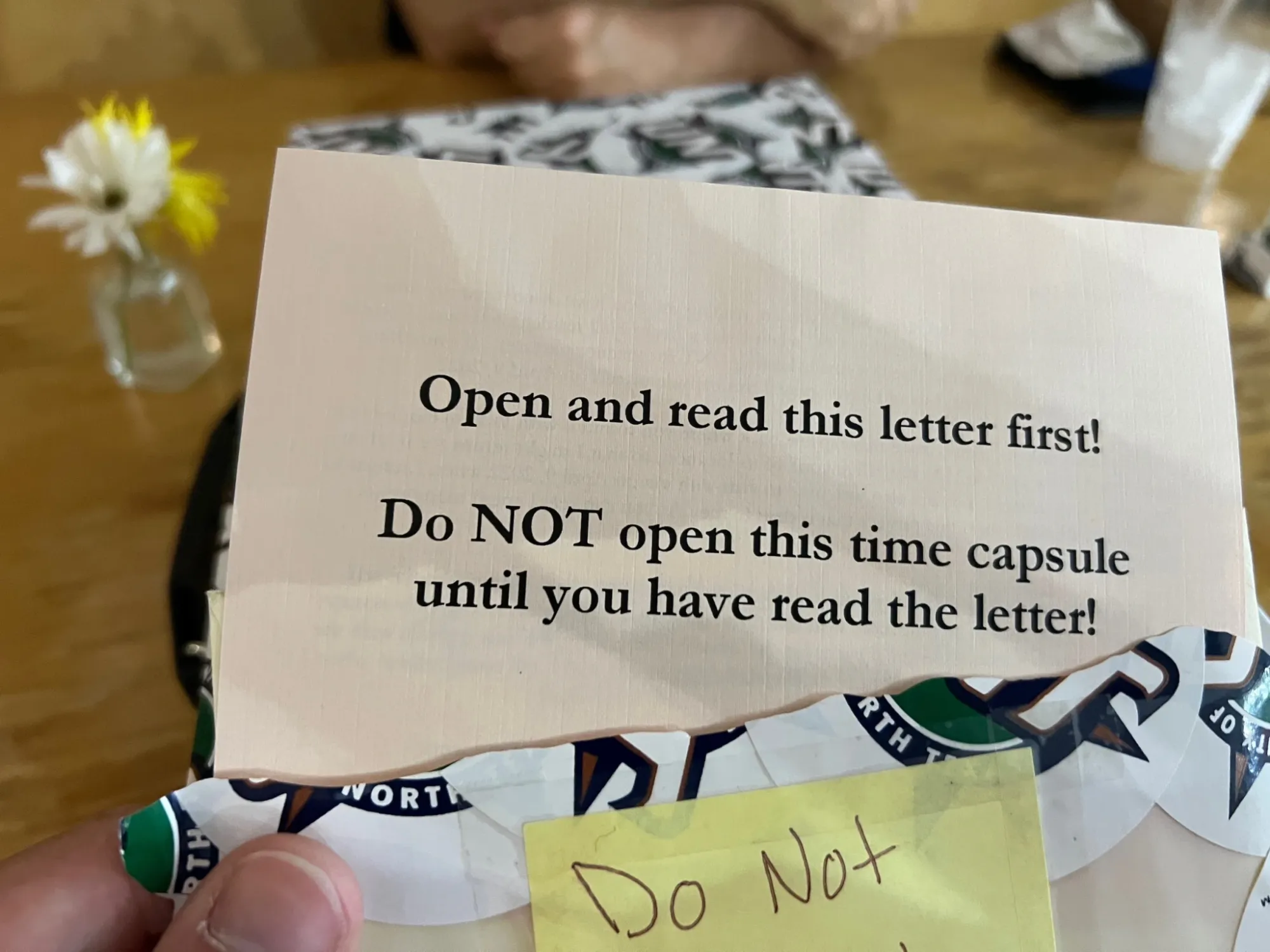 Paper that reads "Open and read this letter first! Do NOT open this time capsule until you have read the letter!"
