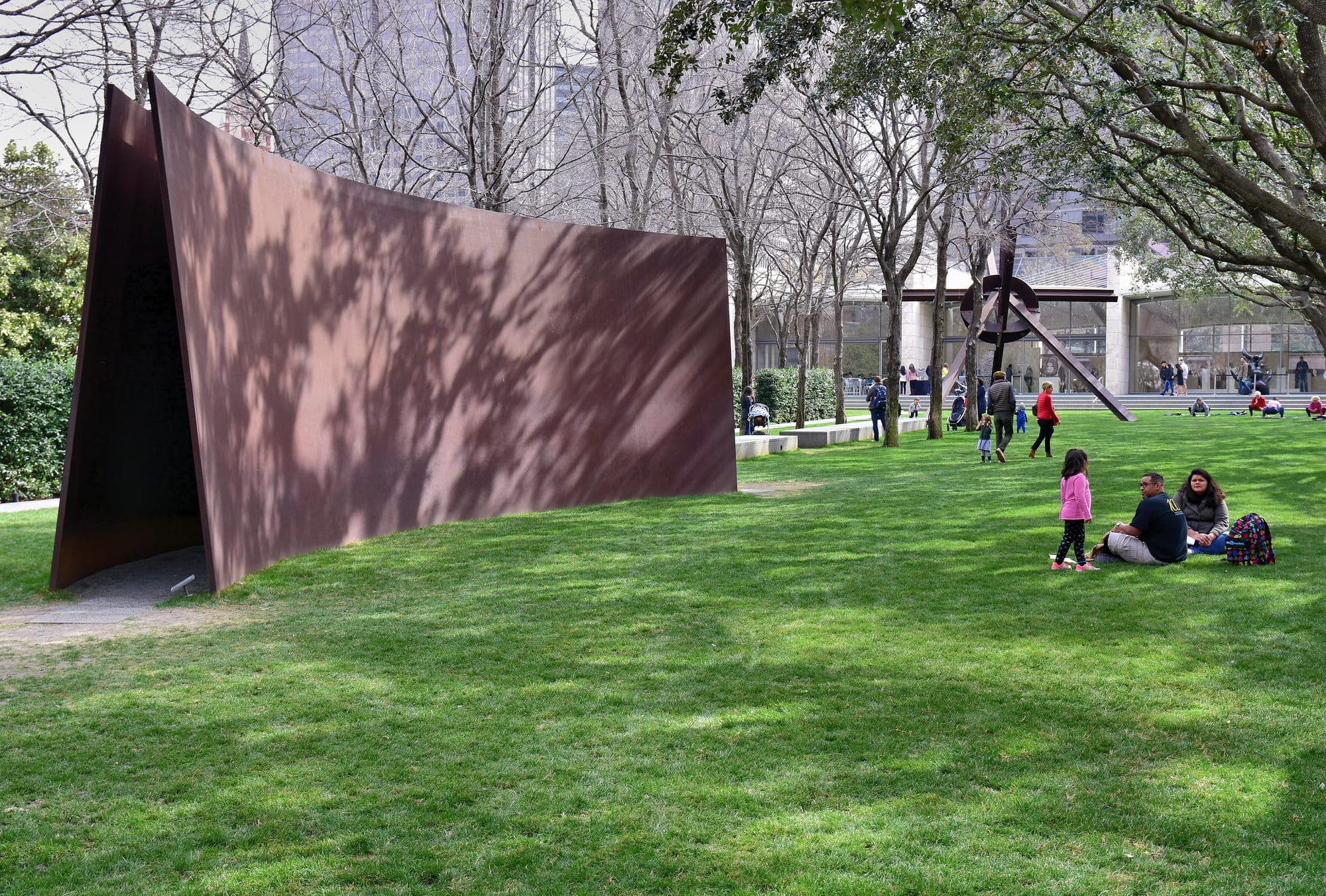 A sculpture garden featuring a Richard Serra work of two curved sheets of weathered steel.